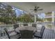 Covered patio features an outdoor ceiling fan, dining table, and chairs for outdoor relaxation at 703 37Th Ave. S, North Myrtle Beach, SC 29582