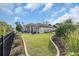 Charming backyard with green grass, manicured landscaping, and a covered patio area perfect for outdoor entertaining at 7584 Regina Ct., Myrtle Beach, SC 29572