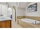Bathroom featuring a soaking tub and a separate walk-in shower with a tiled surround at 7584 Regina Ct., Myrtle Beach, SC 29572