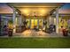 Inviting covered patio with comfortable seating, outdoor decor, ceiling fan, and lush backyard views at 7584 Regina Ct., Myrtle Beach, SC 29572