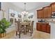 Dining area featuring a table and four wicker chairs, complemented by a bright window with stylish shutters at 7584 Regina Ct., Myrtle Beach, SC 29572