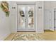 Elegant double doors with plantation shutters, adorned with bows, lead to a bright and airy living space at 7584 Regina Ct., Myrtle Beach, SC 29572