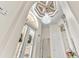 Stunning foyer with high ceilings, a crystal chandelier, and elegant architectural details at 7584 Regina Ct., Myrtle Beach, SC 29572