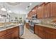 Kitchen with granite countertops, stainless steel appliances, and dark wood cabinets at 7584 Regina Ct., Myrtle Beach, SC 29572
