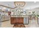 Spacious kitchen island featuring granite countertops, stainless steel appliances, and dark wood cabinets at 7584 Regina Ct., Myrtle Beach, SC 29572