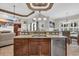 Open-concept kitchen island featuring granite countertops, stainless steel appliances, and dark wood cabinets at 7584 Regina Ct., Myrtle Beach, SC 29572