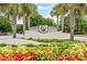 Entrance sign surrounded by vibrant flowers and palm trees at 7584 Regina Ct., Myrtle Beach, SC 29572