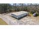 The high-angle aerial view highlights a large warehouse and several outbuildings at 77 Towhee St., Georgetown, SC 29440