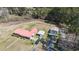 An aerial view of a property with a brick home, carport, and storage shed at 77 Towhee St., Georgetown, SC 29440