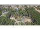 An aerial view shows a house and outbuildings secluded by a dense forest of trees at 77 Towhee St., Georgetown, SC 29440