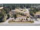 A charming aerial view shows a house with a red roof and surrounding outbuildings at 77 Towhee St., Georgetown, SC 29440