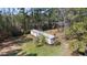 An aerial view of a mobile home on a large lot surrounded by mature trees at 77 Towhee St., Georgetown, SC 29440