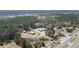 A scenic aerial view reveals a house and outbuildings, with a large warehouse nearby at 77 Towhee St., Georgetown, SC 29440