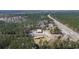 High angle aerial view of property and outbuildings with woods and highway nearby at 77 Towhee St., Georgetown, SC 29440