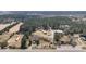 A panoramic aerial view captures a house with outbuildings nestled among lush trees at 77 Towhee St., Georgetown, SC 29440