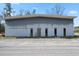 Exterior view of a commercial building featuring multiple entry doors and a neutral color scheme at 77 Towhee St., Georgetown, SC 29440