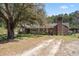 Classic brick home with front porch and a mature tree in the front yard at 77 Towhee St., Georgetown, SC 29440