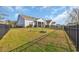 Expansive backyard with lush green grass, framed by a black fence, providing a secure and private outdoor space at 804 Yauhannah Dr., Little River, SC 29566