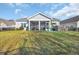 Picture of a spacious backyard with a screened porch and hot tub, ideal for entertaining or relaxing outdoors at 804 Yauhannah Dr., Little River, SC 29566