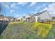 Well-maintained backyard with green grass, a black fence, and a screened porch, providing a private outdoor space at 804 Yauhannah Dr., Little River, SC 29566