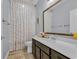 Bathroom featuring a stylish vanity, large mirror, and patterned shower curtain at 804 Yauhannah Dr., Little River, SC 29566
