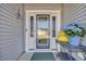 Stylish front door adorned with a decorative wreath and a charming side table with fresh flowers at 804 Yauhannah Dr., Little River, SC 29566