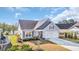 Well-maintained property with a two-car garage, manicured lawn, and tasteful landscaping in a residential area at 804 Yauhannah Dr., Little River, SC 29566
