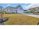 Inviting single-Gathering home with a well-kept lawn, complemented by mature shrubs and a double garage at 804 Yauhannah Dr., Little River, SC 29566