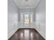 Elegant foyer with hardwood flooring, decorative wainscoting, and a stylish front door with glass panels at 804 Yauhannah Dr., Little River, SC 29566