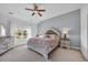 Main bedroom suite featuring a decorative ceiling fan, a large bed, and natural light at 804 Yauhannah Dr., Little River, SC 29566
