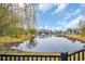 Scenic view of a peaceful pond with a fountain, surrounded by mature trees and lush greenery at 804 Yauhannah Dr., Little River, SC 29566