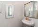 Bathroom featuring a white pedestal sink and large mirror, complemented by neutral paint and decor at 8081 Bear Claw Way, Conway, SC 29526
