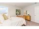 Bedroom with a neutral-colored bed, wooden dresser, and an artistic painting on the wall at 8081 Bear Claw Way, Conway, SC 29526
