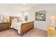 Bedroom with a wooden bed frame, white bedding, bedside tables, and a large window at 8081 Bear Claw Way, Conway, SC 29526
