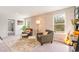 Inviting living room with armchairs, accent rug, and natural light through the windows at 8081 Bear Claw Way, Conway, SC 29526