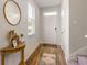 Inviting entryway features wood-look floors, a stylish round mirror, and a welcoming front door at 8081 Bear Claw Way, Conway, SC 29526