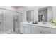 Bathroom with double sink vanity, large mirror, and glass enclosed shower at 8085 Bear Claw Way, Conway, SC 29526