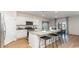 Bright open kitchen featuring white cabinets, granite counters, and a stylish island with seating at 8085 Bear Claw Way, Conway, SC 29526
