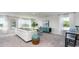 Spacious living room filled with natural light from the large windows, and a modern sofa at 8085 Bear Claw Way, Conway, SC 29526