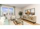 Cozy living room boasts lake views from the large window, comfortable seating, and stylish decor at 8085 Bear Claw Way, Conway, SC 29526