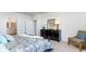 Comfortable main bedroom with neutral walls, a large dresser, and a sitting chair at 8085 Bear Claw Way, Conway, SC 29526