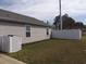 Backyard features a partial lawn, privacy fence, and the exterior siding of a single story home at 1001 Leatherman Rd., Conway, SC 29527