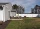 Home's backyard featuring green grass, a white fence, and a patio area at 1001 Leatherman Rd., Conway, SC 29527