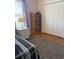 Bedroom with a tan bookshelf, closet, and a black and white striped bed at 1001 Leatherman Rd., Conway, SC 29527