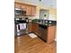 Functional kitchen featuring stainless steel appliances, wooden cabinetry, ample counter space, and sink with faucet at 1001 Leatherman Rd., Conway, SC 29527
