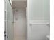 Standard bathroom featuring a white shower with glass door, toilet, and tiled walls at 5616 N Kings Hwy., Myrtle Beach, SC 29577