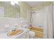 Cozy bathroom featuring a vintage bathtub, toilet, and sink beneath a large mirror at 5616 N Kings Hwy., Myrtle Beach, SC 29577