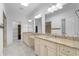 Bathroom featuring granite counters, dual sinks, and large vanity mirrors at 5616 N Kings Hwy., Myrtle Beach, SC 29577