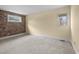 Comfortable bedroom featuring a brick accent wall and natural light from two windows at 5616 N Kings Hwy., Myrtle Beach, SC 29577