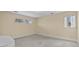 Bright bedroom with neutral walls, large window, and cozy carpet flooring at 5616 N Kings Hwy., Myrtle Beach, SC 29577